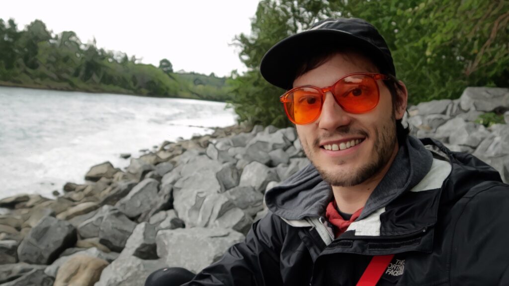ScootyDub smiling in orange glasses by the Bow River