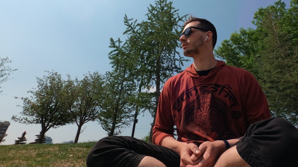 ScootyDub meditating in the grass in Bridgeland Calgary