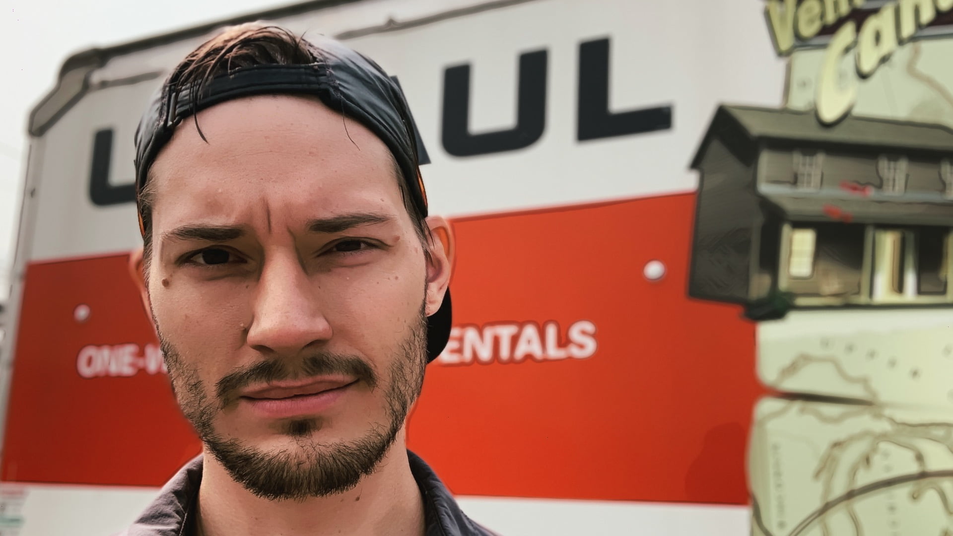 Scootydub squinting in front of a uhaul on moving day