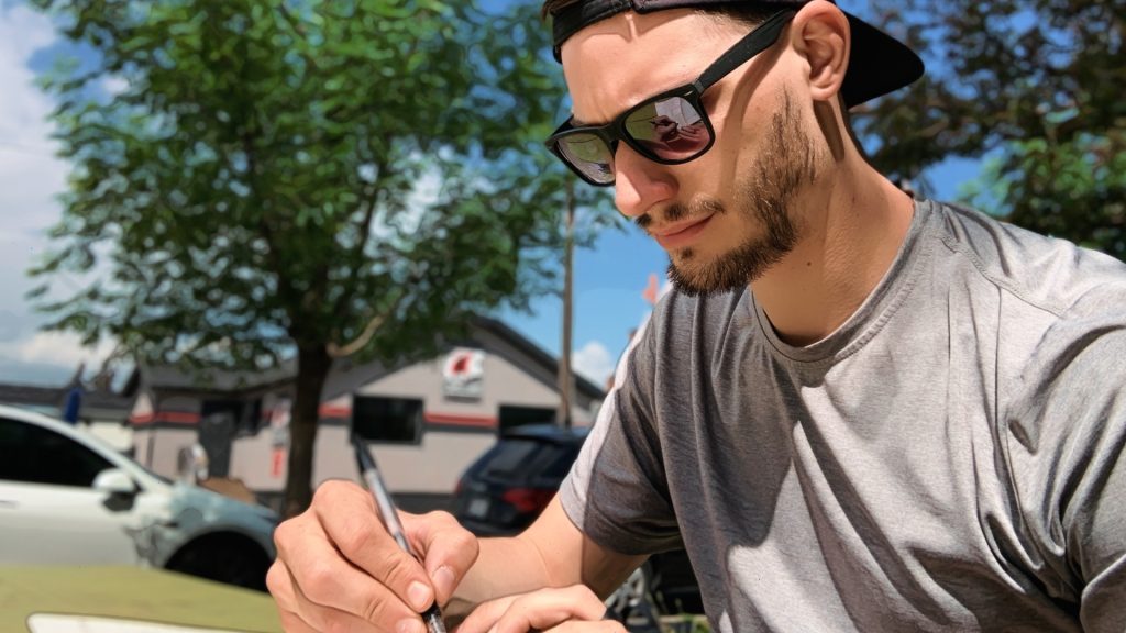 ScootyDub journaling at a picnic table in Bridgeland.