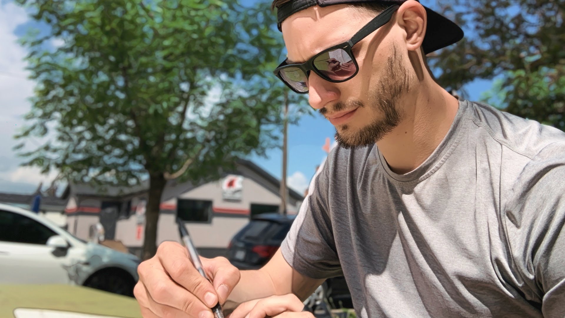 ScootyDub journaling at a picnic table in Bridgeland.