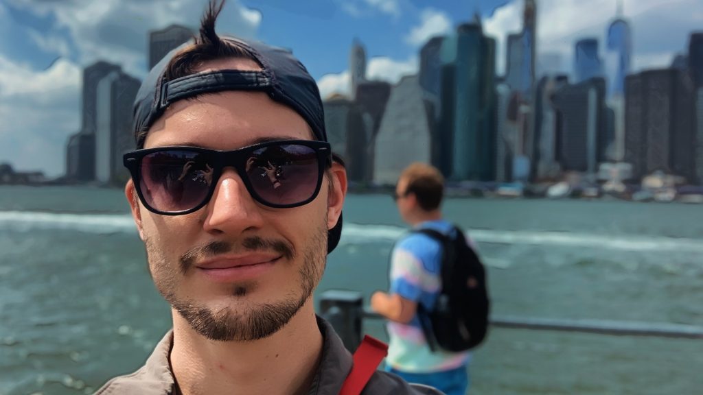ScootyDub smiling in front of the Manhattan skyline