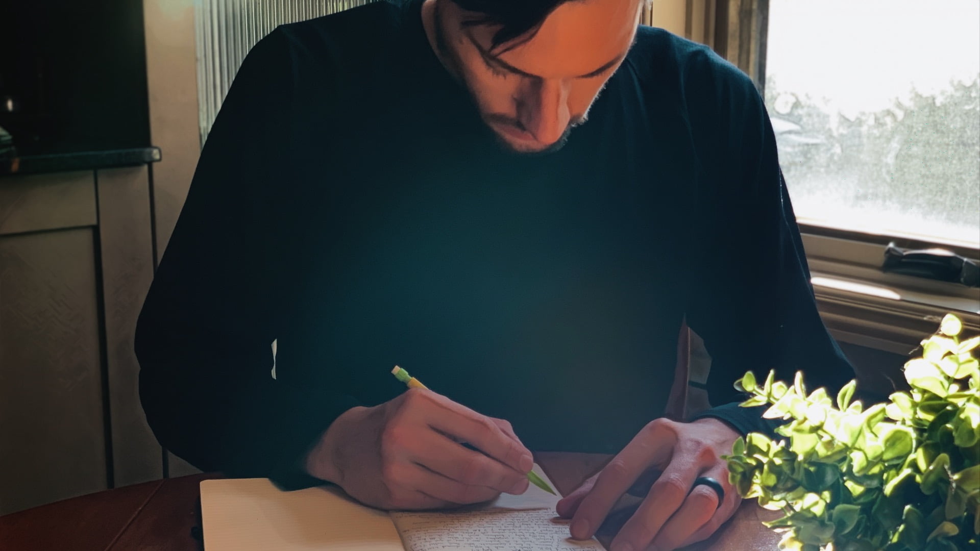 ScootyDub writing at the kitchen table