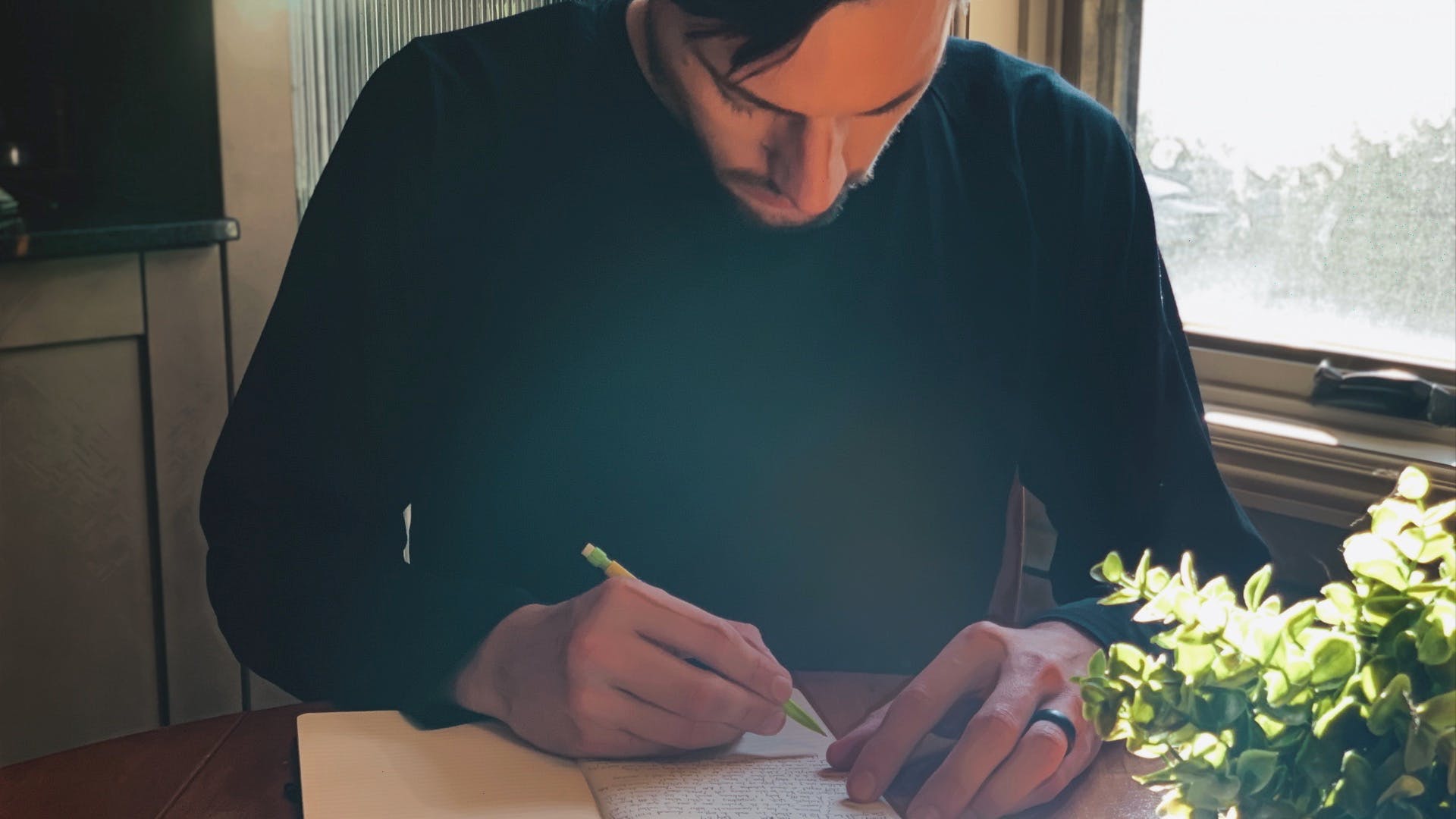 Scootydub journaling at the kitchen table