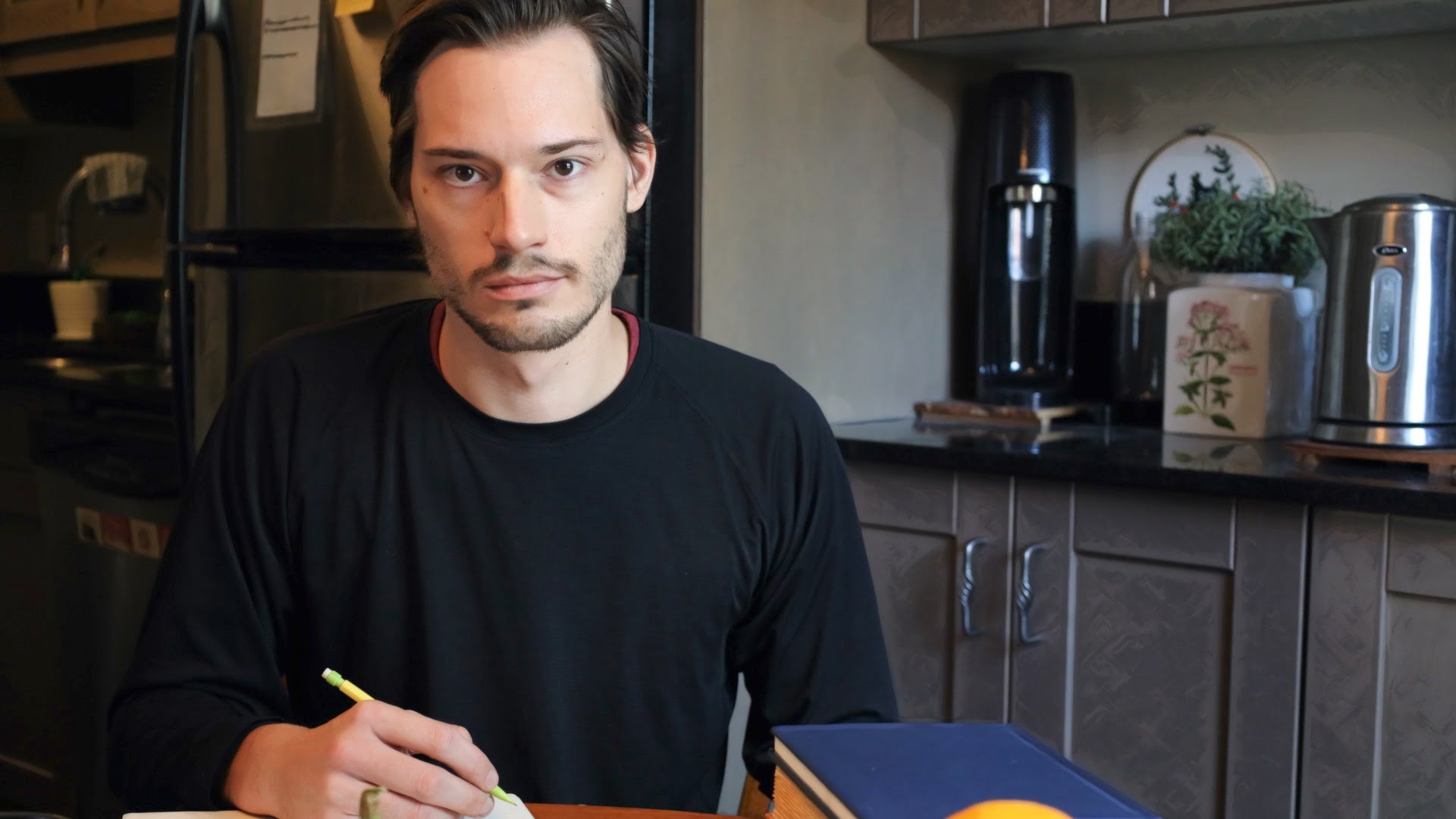 ScootyDub staring from across the table with a pencil in his hand